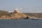 Sea gulf and defensive tower on rocky coast. Cala Mesquida, Menorca, Spain