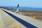 A sea gull takes to the air from the sea wall.