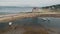 Sea gulls flying at brown sand beach on ocean shore aerial. Nature seascape with old castle ruins