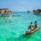 Sea Gypsy Kids on their sampan with their house on stilts in the