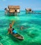 Sea Gypsy Kids on their sampan at their house on stilts