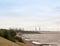 sea industry cargo and shipping cranes in the distance beach groynes Harwich Port