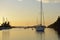 Sea kayaker and anchored boats in Princess Bay at sunset, Wallace Island, Gulf Islands, British Columbia