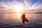 Sea Kayaking in calm waters during a colorful and vibrant sunset.