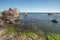 Sea kayaking overlooking Pacific ocean, rocky cliffs and caves, California