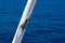 Sea knot on a white flagpole on sail boat on water surface