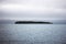 Sea landscape with alone island on horizon. Japan sea in twiligh