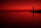 Sea Landscape In Dark Red Tones With The Silhouette Of A Sunken Ship And An Old Lighthouse. Seascape In Red Color. Artistic Scene