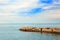 Sea landscape. Group of seagulls sitting on breakwater.