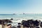 Sea landscape midday with rocks waves and constructions of the new pier and gulls