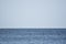 Sea line of the horizon. Sea and sky. The waves and glare of the sun are reflected from the waves of the sea. Seascape.