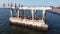 Sea lions sleeping and taking sunbathing on old damaged bridge part in water like island near city port