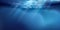 Sea or ocean surface seen from underwater, background. Surface seen from under water. Rays of light, abstract marine backdrop.