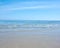 Sea and ocean view of waves washing onto an empty and relaxing tropical beach on a warm, summer day. Seascape with clear