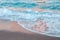 Sea ocean wave water with white foam. Sea sandy beach outdoor. Natural water aquatic blue turquoise aquamarine colorful background