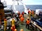 The Sea of Okhotsk / Russia - July 09 2015: Science expedition team on the stern of RV Akademik Lavrentyev waiting for equipment r