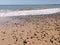 Sea pebbles, blue sea, waves, bright sun.