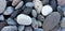 Sea pebbles closeup. Background of beach pebbles of different shape and size