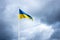 Sea pennant in Swedish flag colors on cloudy dramatic sky background. 6 June. Flag of Sweden waving high on the flagpole.