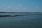 Sea pier with seagulls, blue sea and sky