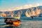 Sea, pleasure boats, rocky shores in the fjords of the Gulf of Oman