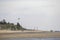 Sea recreation and vacation. Kites and people walking on the sandy beach.Wadden Sea. Silhouettes of people on the