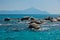 Sea rocks with holy mountain Athos in background near coast of Sithonia