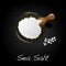 Sea salt in ceramic bowl for cooking or spa, isolated on dark background