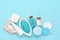 Sea salt, cream, lotion, soap, sponges and shells in cosmetics set for spa on blue background. Top view with space for text