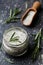 Sea salt scented herb rosemary on black stone background