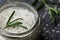 Sea salt scented herb rosemary on black stone background