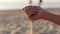 Sea sand in a women`s hand. Female hand holds a sand. Sand pours from the hand.