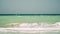 The sea in several colors, waves, clear sky