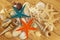Sea shells and colorfully painted Starfishes on brown wooden background. Top down view.