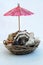 Sea shells with umbrella cocktail decoration. Pink cocktail decoration in a seashells.