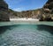 Sea shore of secluded sandy beach between rocks