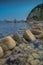 Sea shore with transparent water and stones at the bottom.