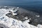 Sea shore in winter, covered with ice and snow. Round ice floes floating in sea
