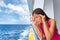 Sea sickness tourist woman seasick on cruise ship travel vacation feeling ill with nausea and headache migraine. Holiday anxiety