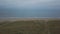 Sea side with a green field and beach capturing air video with drone , on a autumn day.