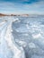 Sea slush and ice floes on the sea surface in winter during sunset.