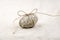 Sea smooth oval pebble with bow isolated linen background.