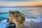 Sea stack and waves in the Pacific Ocean at sunset, seen from a