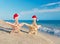 Sea-stars couple in santa hats walking at beach. Holiday concept