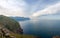 Sea steep rocky shore and sea section in cloudy morning