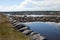 Sea stone dam and serpantine embankments on the background of the arched dam gates