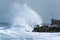 Sea storm waves crashing and splashing against jetty