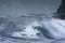 Sea storm waves dramatically crashing and splashing against rocks