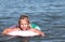 Sea, summer, child, girl, five-year-old, blonde, floats on an inflatable lifebuoy