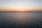 Sea sunrise early morning. Aerial View. Black Sea Sunset. Orange sky and low tide. Sea waves in the rays of a sunset. Sunset on th